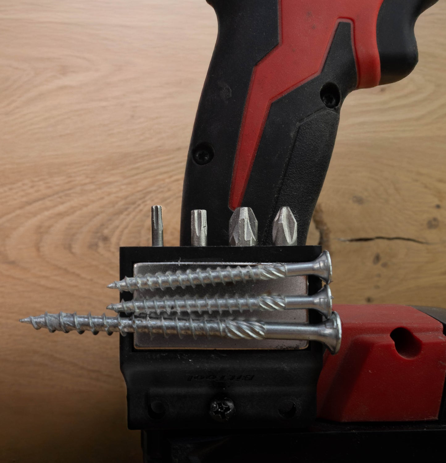BitTool magnetic bit holder attached to cordless drill, securely holding multiple bits and screws with strong magnet